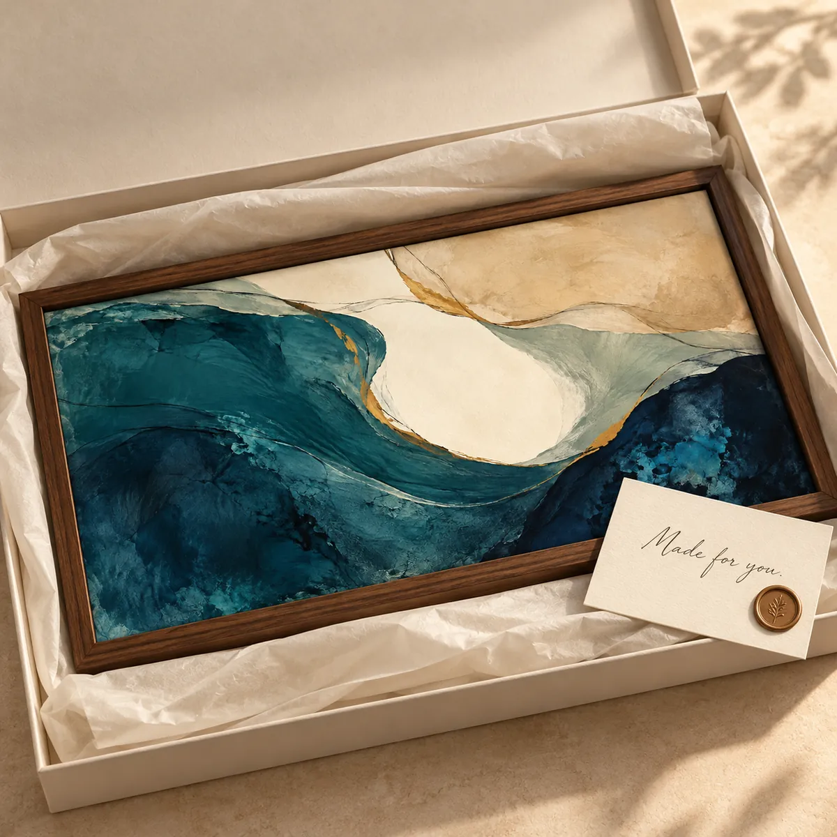 A framed artwork in a gift box with a card